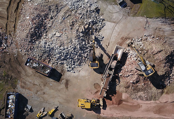 Bagger auf Abbruchbaustelle von oben